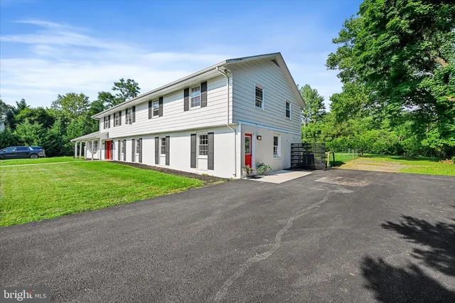 a front view of house with yard and green space