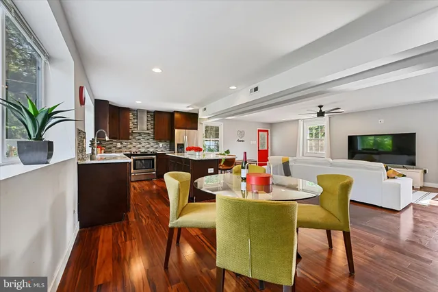 a dining room with furniture window and wooden floor