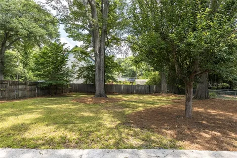a view of a yard with a tree