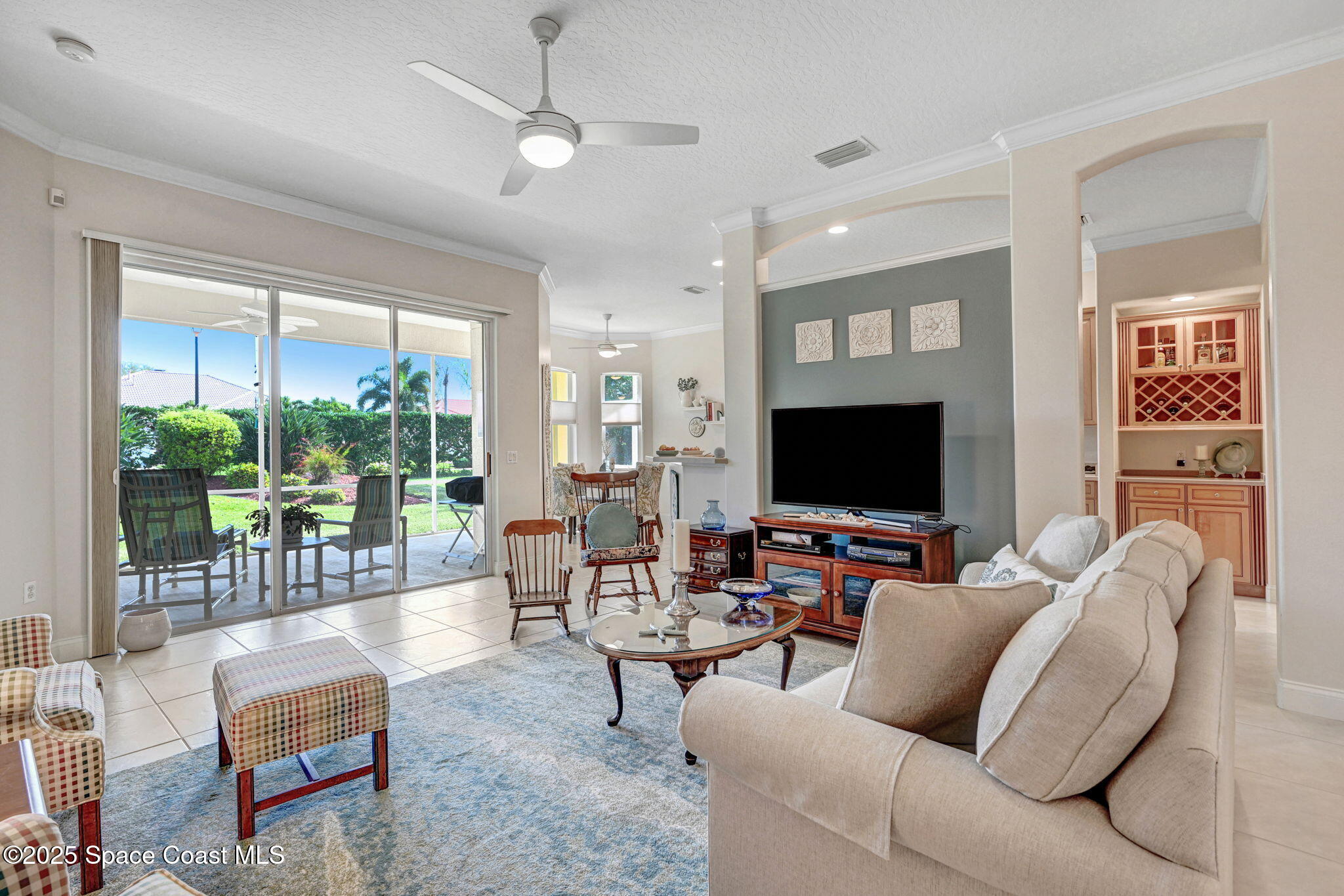 507 Royston Lane Melbourne, FL 32940 - Photo 24 of 52 a living room with furniture and a flat screen tv