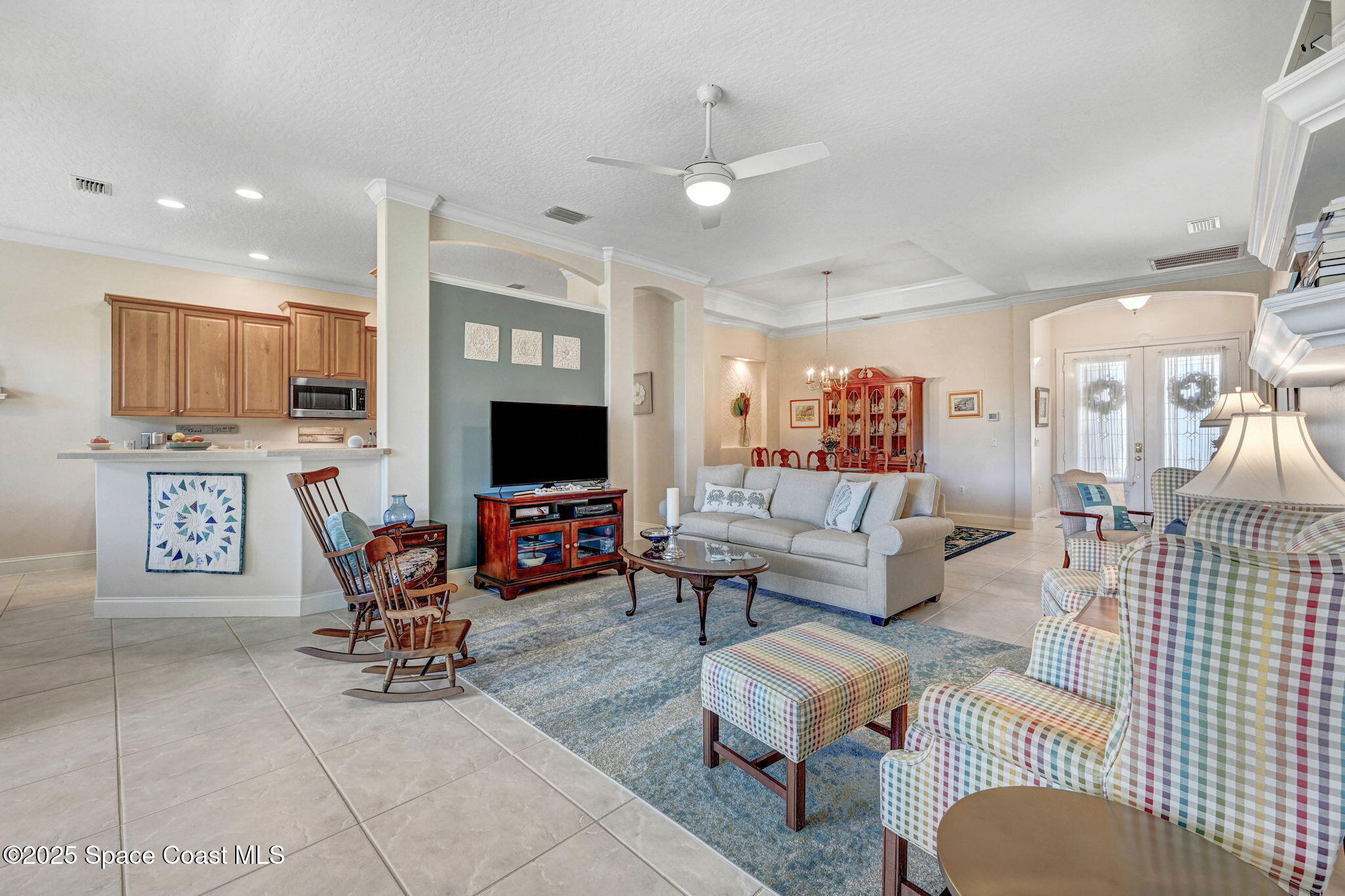 507 Royston Lane Melbourne, FL 32940 - Photo 25 of 52 a living room with furniture a flat screen tv and kitchen view