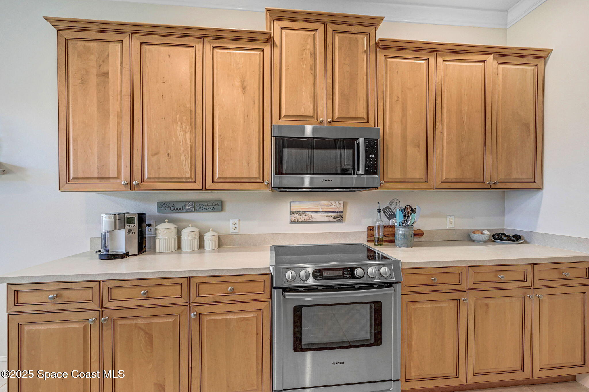 507 Royston Lane Melbourne, FL 32940 - Photo 33 of 52 a kitchen with stainless steel appliances granite countertop white cabinets a stove top oven with wooden floor