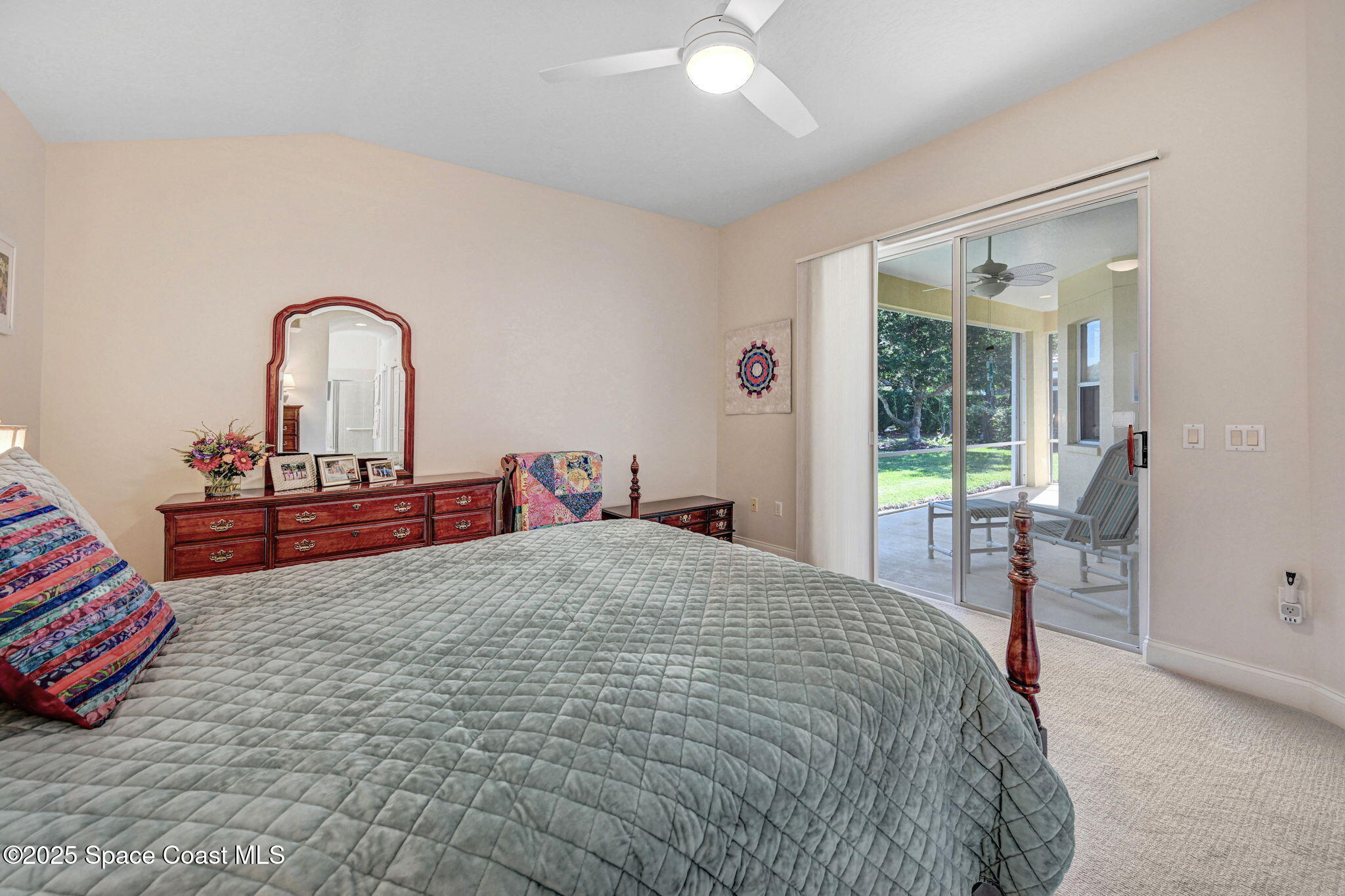 507 Royston Lane Melbourne, FL 32940 - Photo 38 of 52 a bedroom with a bed and a dresser next to a window