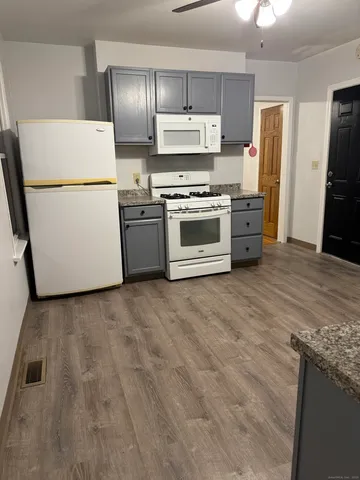 a kitchen with stainless steel appliances and white cabinets