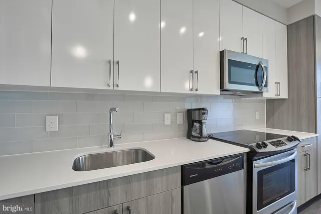 a kitchen with a sink stove and microwave