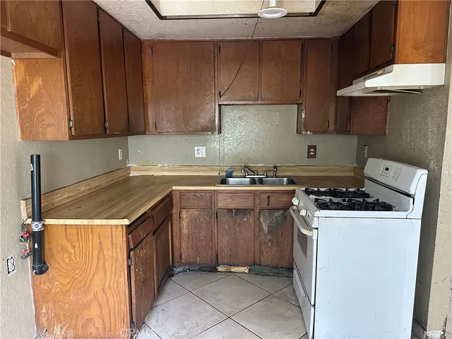 a kitchen with a stove a sink and a refrigerator