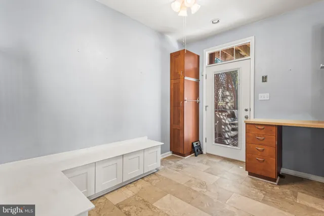 a view of a livingroom with a ceiling fan and window