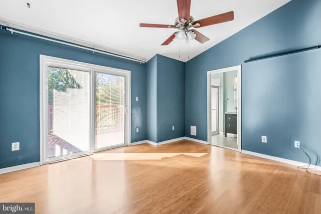 a view of a livingroom with a chandelier fan and a window