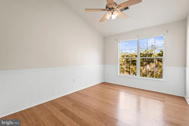 a view of empty room with wooden floor