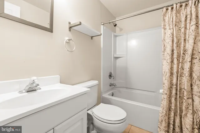 a view of an empty room with a fireplace and entryway