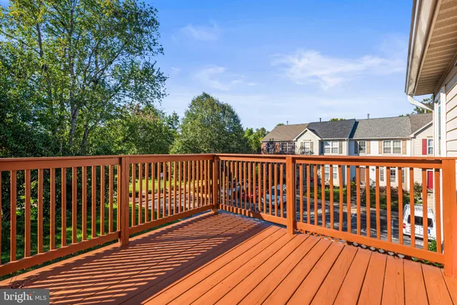 a view of balcony with wooden floor and fence