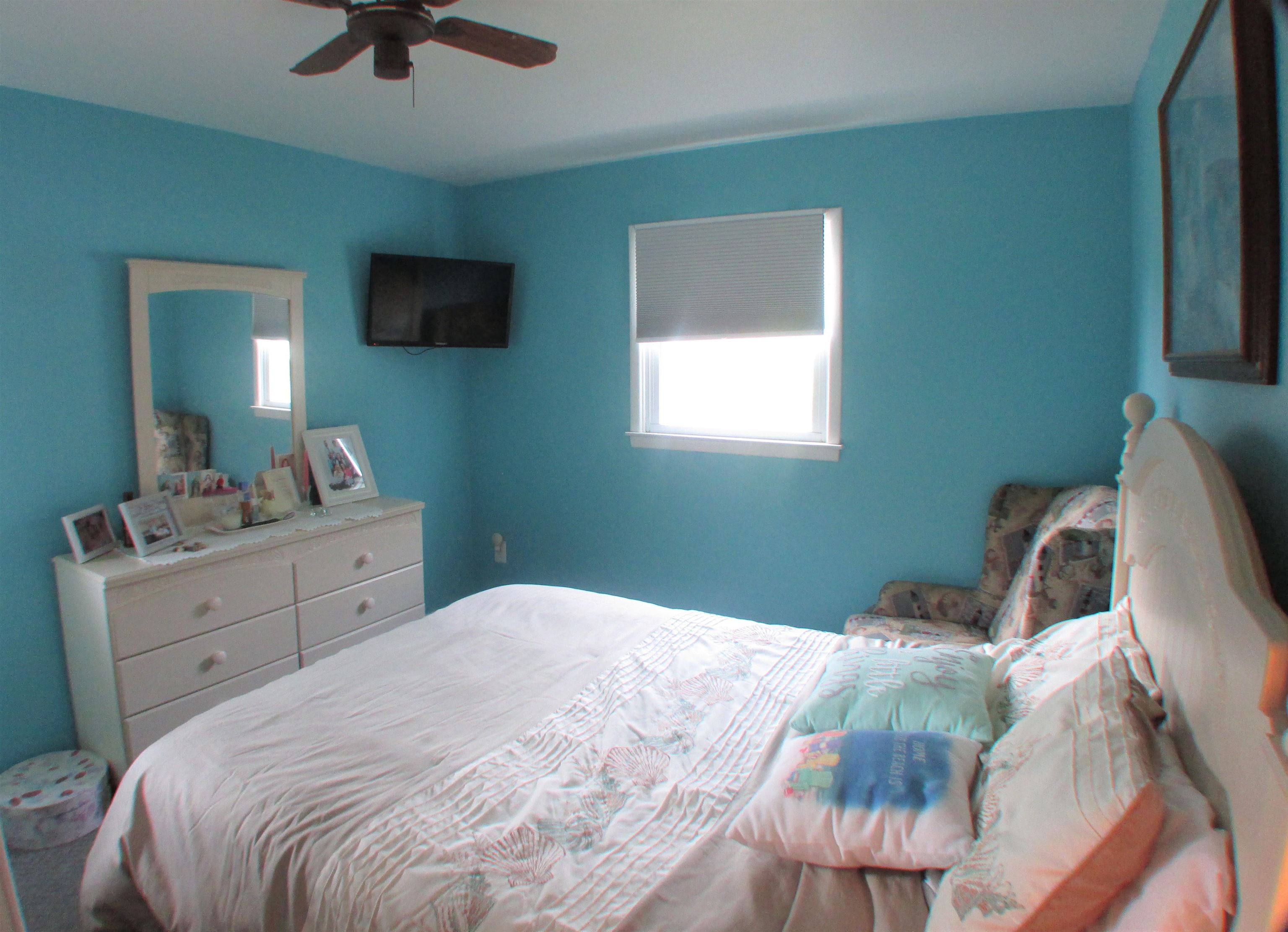 101 Kenvil Road North Cape May, NJ 08204 - Photo 12 of 27 a bedroom with a bed and a flat screen tv