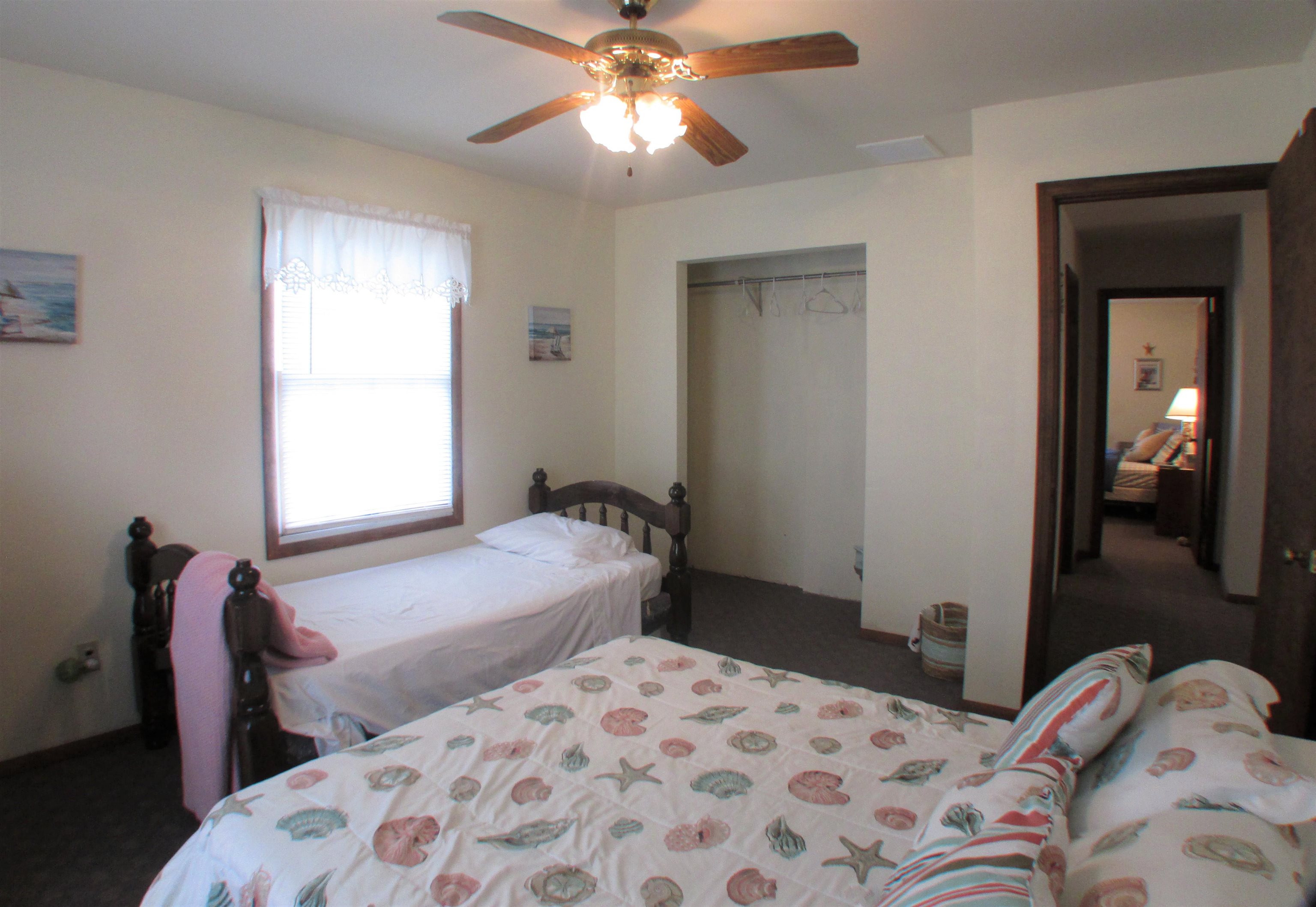 101 Kenvil Road North Cape May, NJ 08204 - Photo 16 of 27 a bedroom with a bed and a chandelier