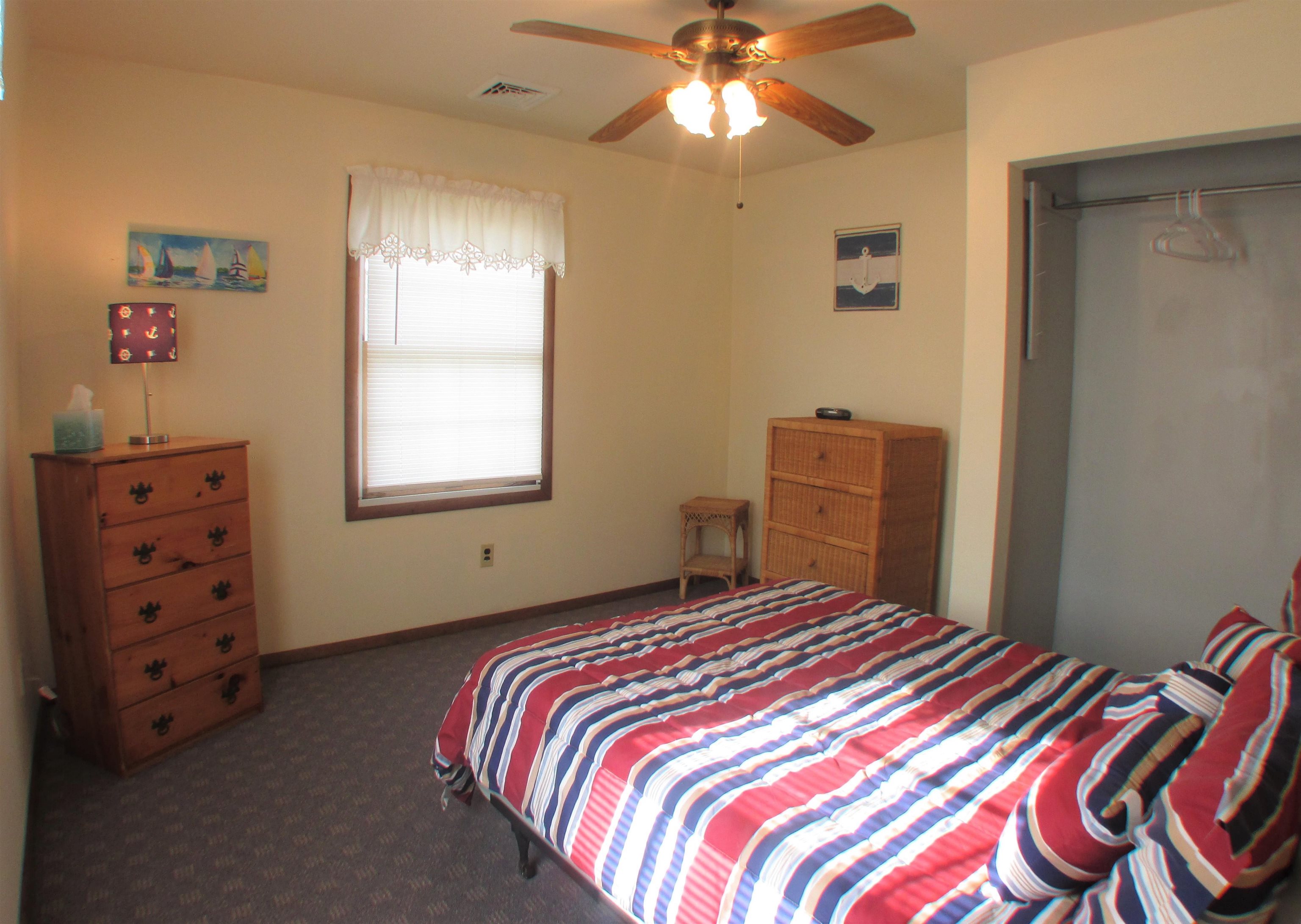 101 Kenvil Road North Cape May, NJ 08204 - Photo 20 of 27 a bedroom with a bed and a chandelier