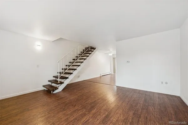 a view of an empty room with wooden floor