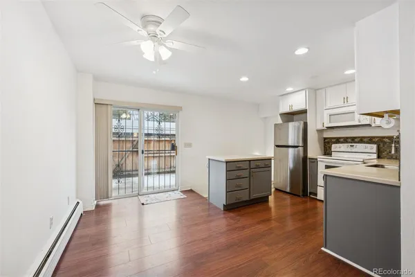 a kitchen with a refrigerator and a stove top oven