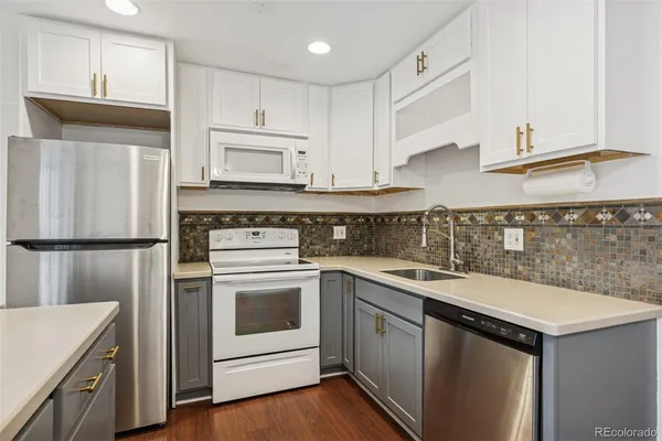 a kitchen with a sink stove and cabinets