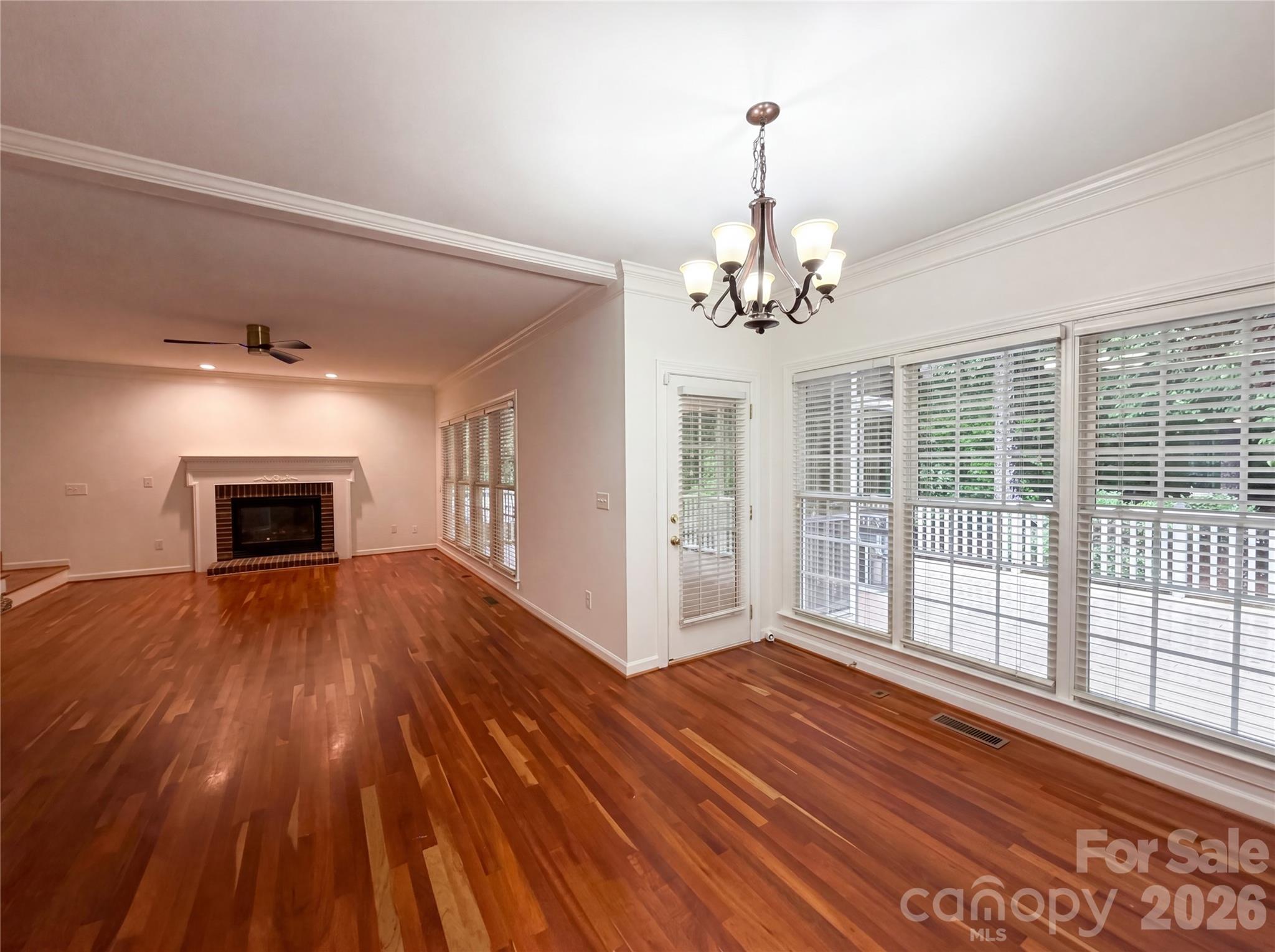 12341 Willingdon Road Huntersville, NC 28078 - Photo 8 of 17 a view of empty room with wooden floor and fan