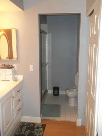 a bathroom with a sink toilet and shower