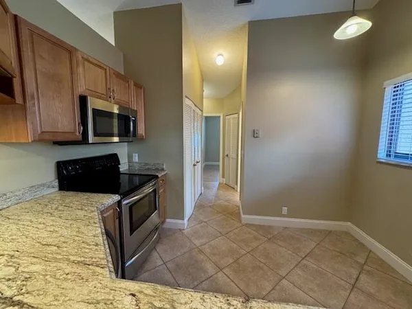 a kitchen with granite countertop a sink and a stove top oven