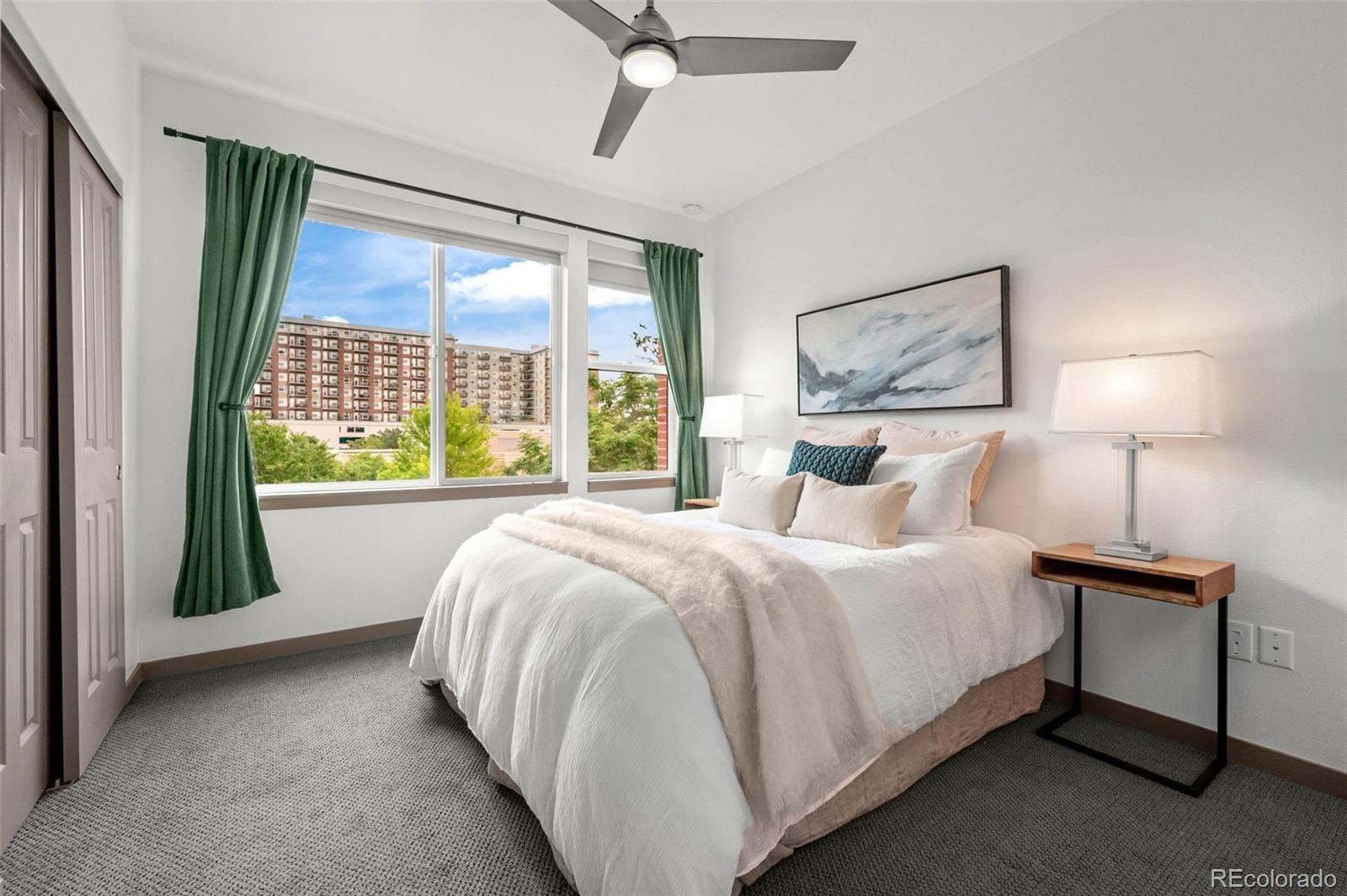 2200 Tremont Place, Unit 5 Denver, CO 80205 - Photo 15 of 22 a bed sitting in a bedroom next to a window