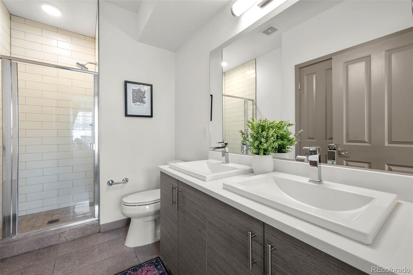 2200 Tremont Place, Unit 5 Denver, CO 80205 - Photo 16 of 22 a bathroom with a sink toilet and shower