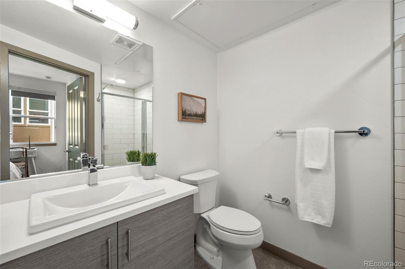 2200 Tremont Place, Unit 5 Denver, CO 80205 - Photo 19 of 22 a bathroom with a sink toilet and shower