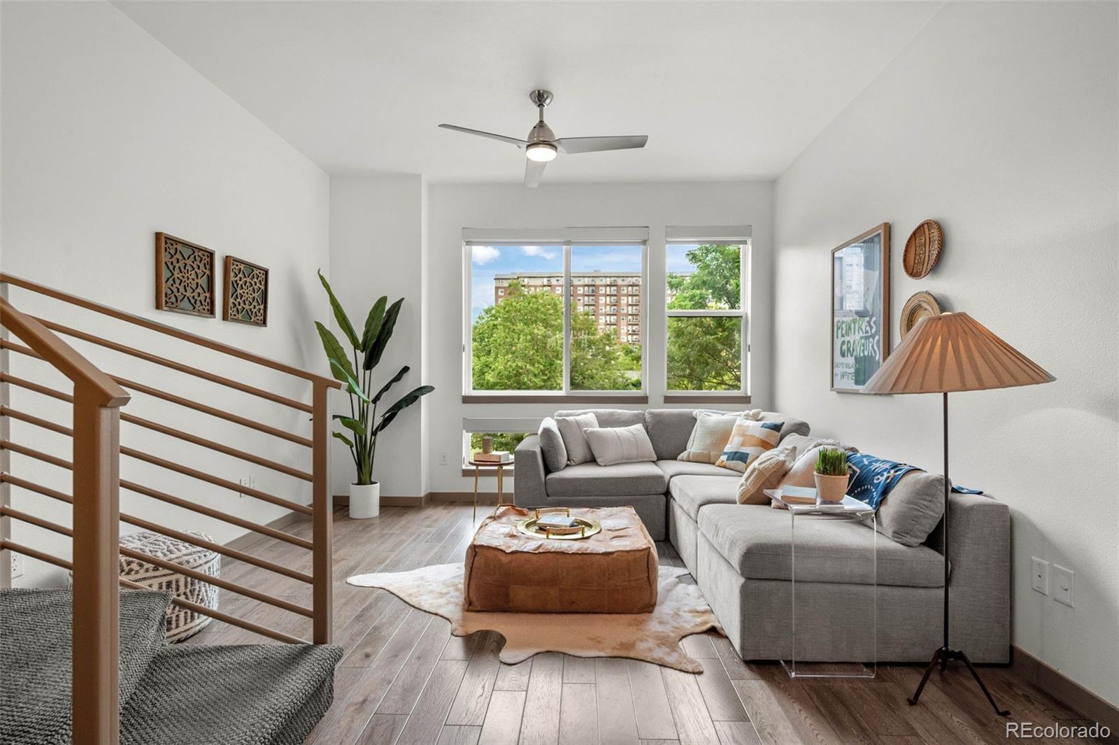 2200 Tremont Place, Unit 5 Denver, CO 80205 - Photo 3 of 22 a living room with furniture and a large window