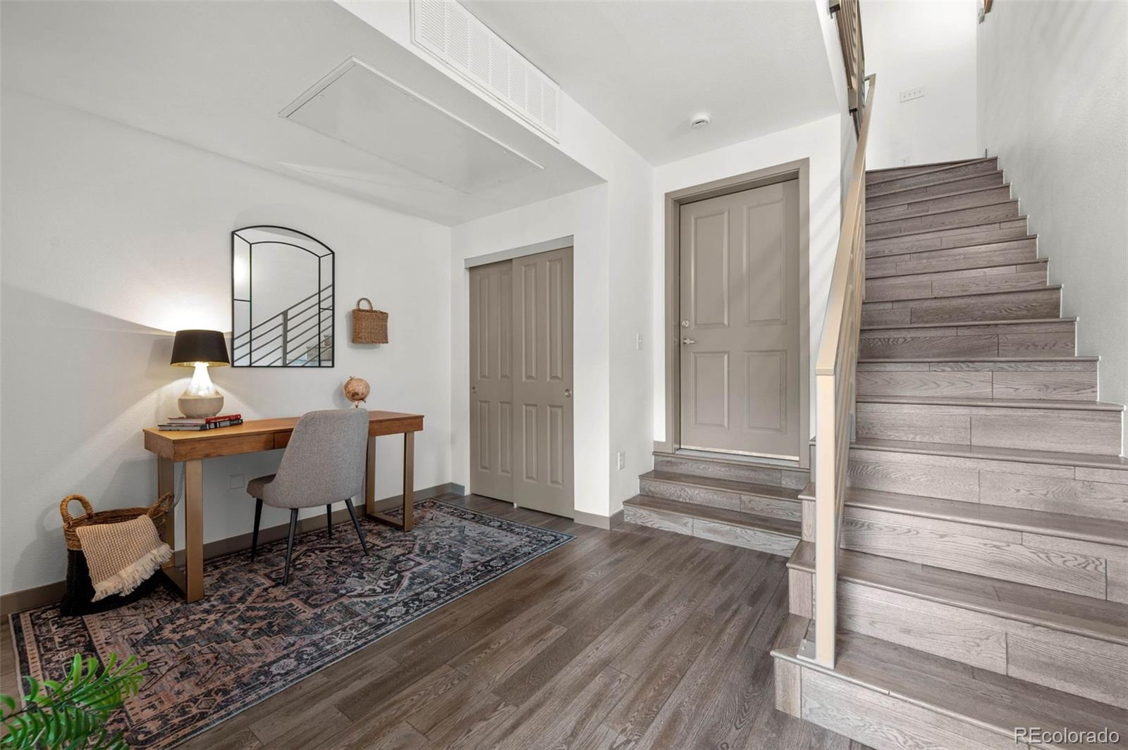 2200 Tremont Place, Unit 5 Denver, CO 80205 - Photo 5 of 22 a view of a livingroom with wooden floor and furniture