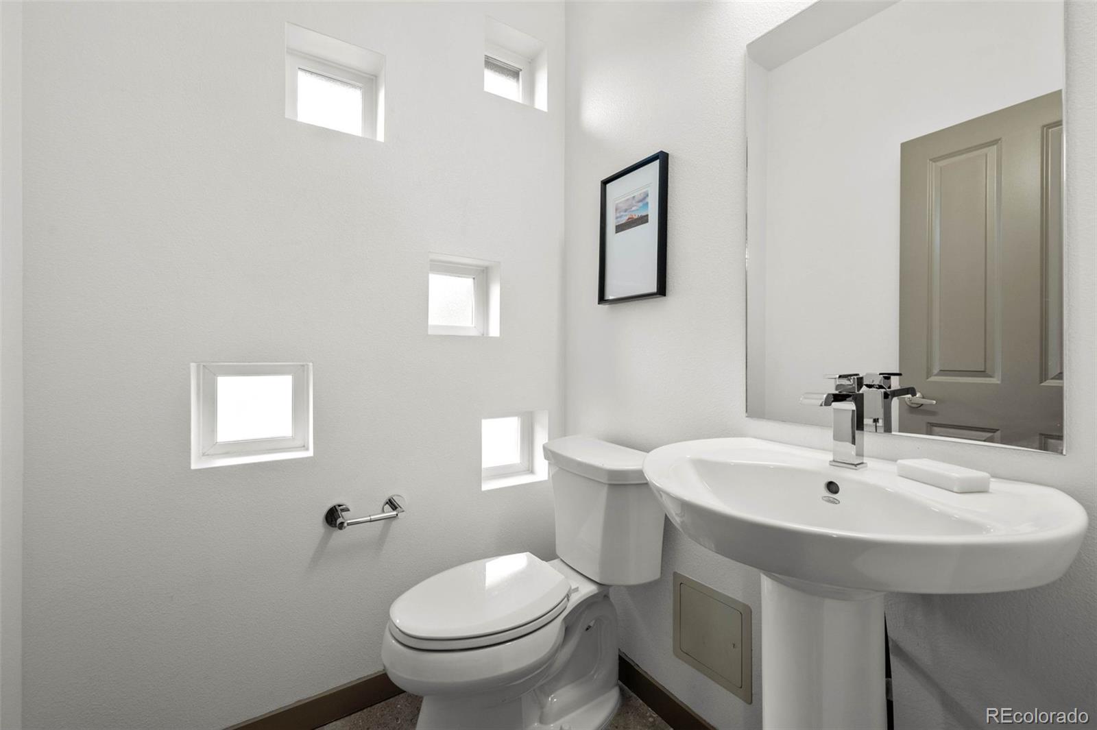 2200 Tremont Place, Unit 5 Denver, CO 80205 - Photo 6 of 22 a bathroom with a sink and toilet