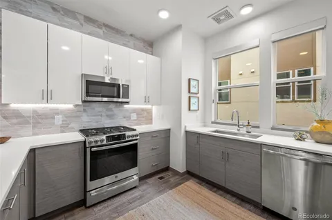 a kitchen with stainless steel appliances a sink stove and microwave