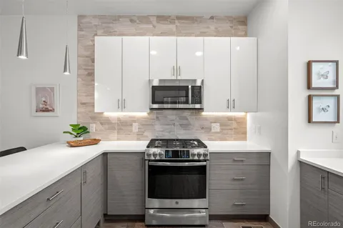 a kitchen with stainless steel appliances a stove a microwave sink and cabinets