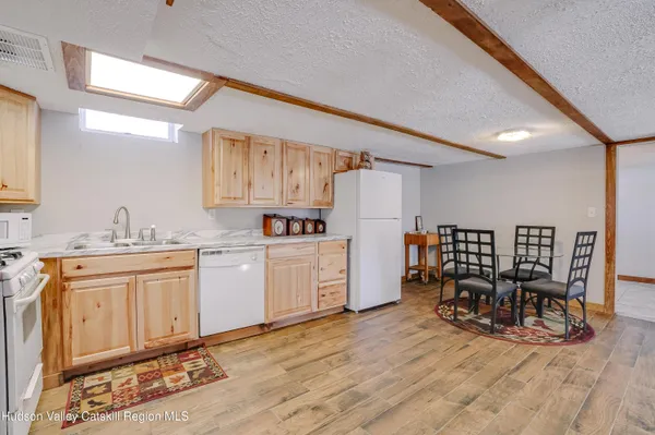 a kitchen with white cabinets and chairs
