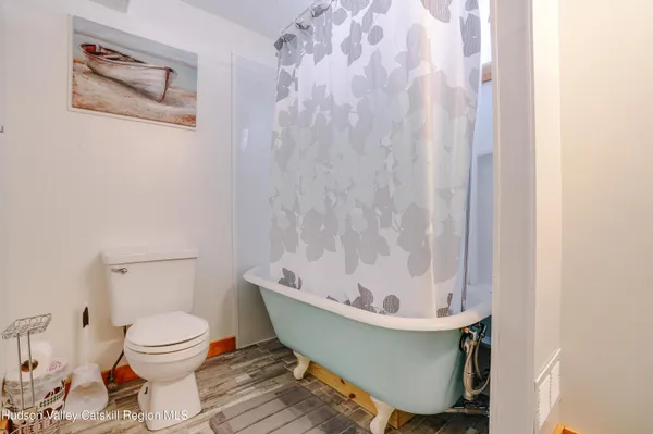 a white bath tub sitting next to a white toilet