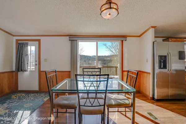 a view of a dining room with furniture window and wooden floor