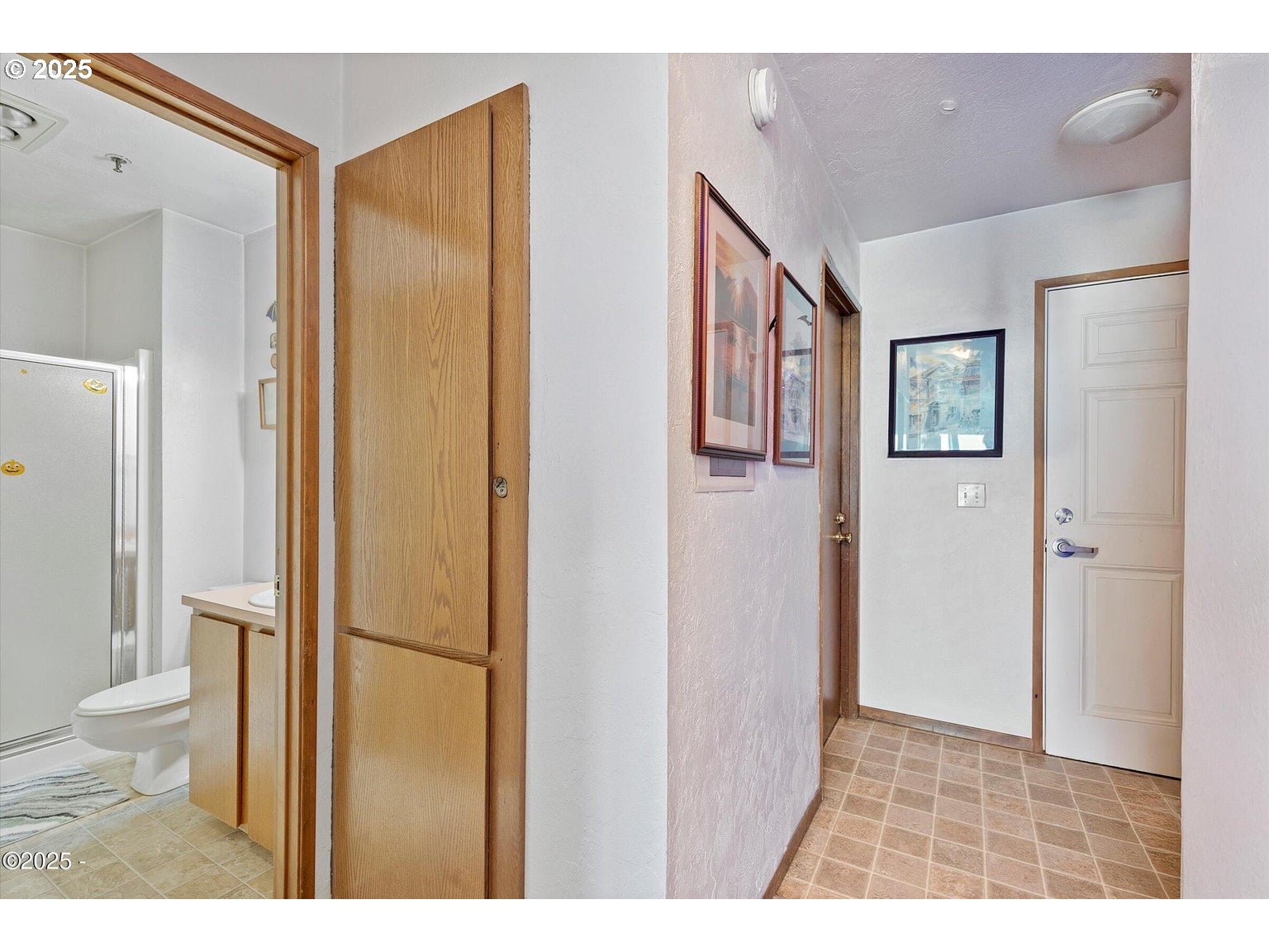 507 Northwest Alpine Street, Unit 204 Newport, OR 97365 - Photo 12 of 30 a bathroom with a toilet sink and a mirror