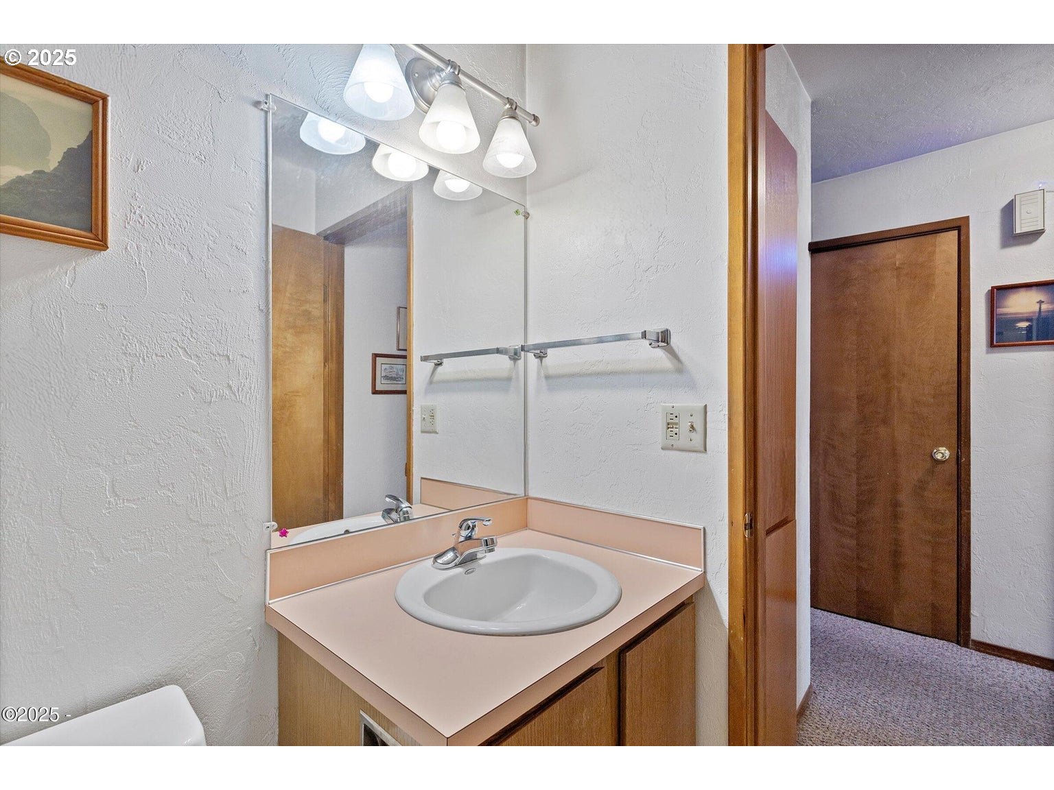 507 Northwest Alpine Street, Unit 204 Newport, OR 97365 - Photo 14 of 30 a bathroom with a sink and a mirror