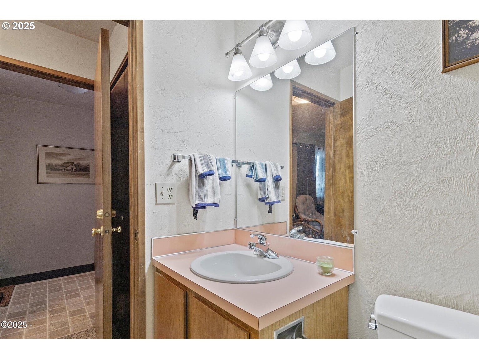 507 Northwest Alpine Street, Unit 204 Newport, OR 97365 - Photo 18 of 30 a bathroom with a sink vanity and a mirror