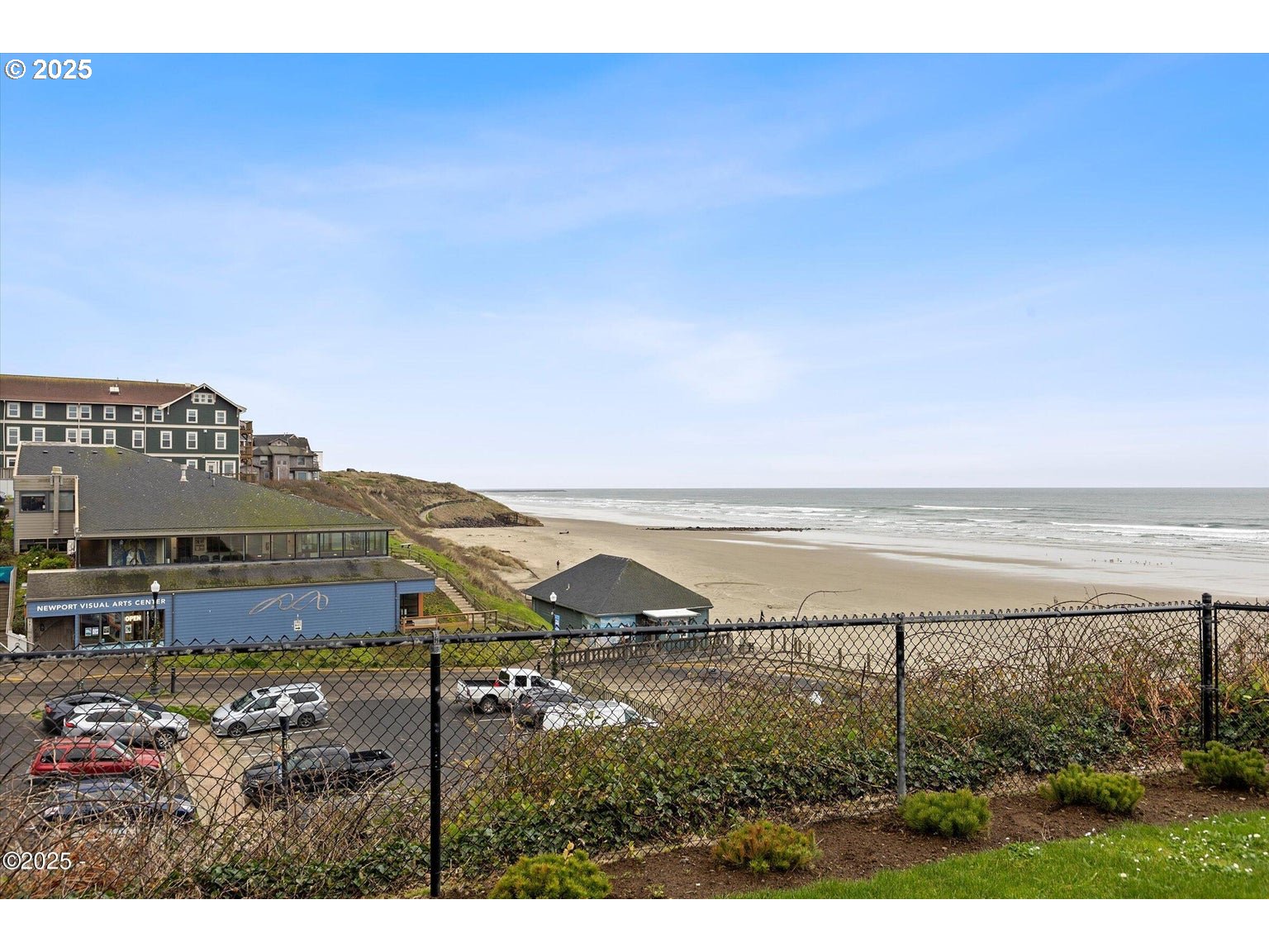 507 Northwest Alpine Street, Unit 204 Newport, OR 97365 - Photo 24 of 30 a view of an ocean and a building