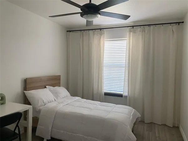 a bedroom with a bed and a window