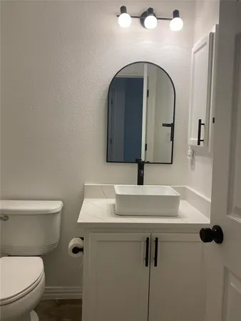 a bathroom with a toilet sink and mirror