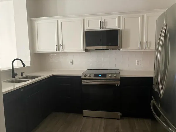 a kitchen with a sink and stainless steel appliances