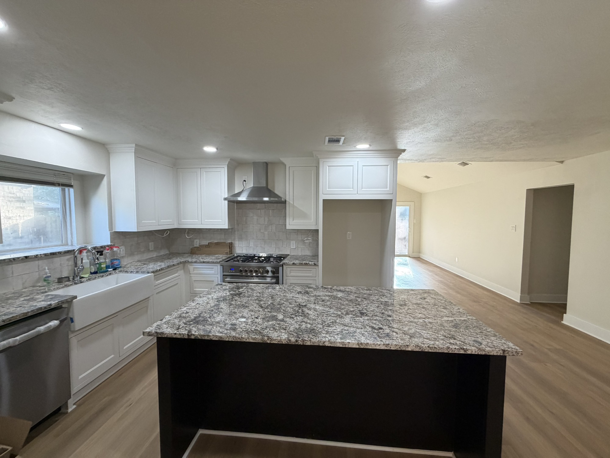 70 Brookflower Road Spring, TX 77380 - Photo 11 of 16 a kitchen with granite countertop kitchen island stainless steel appliances a sink stove and refrigerator