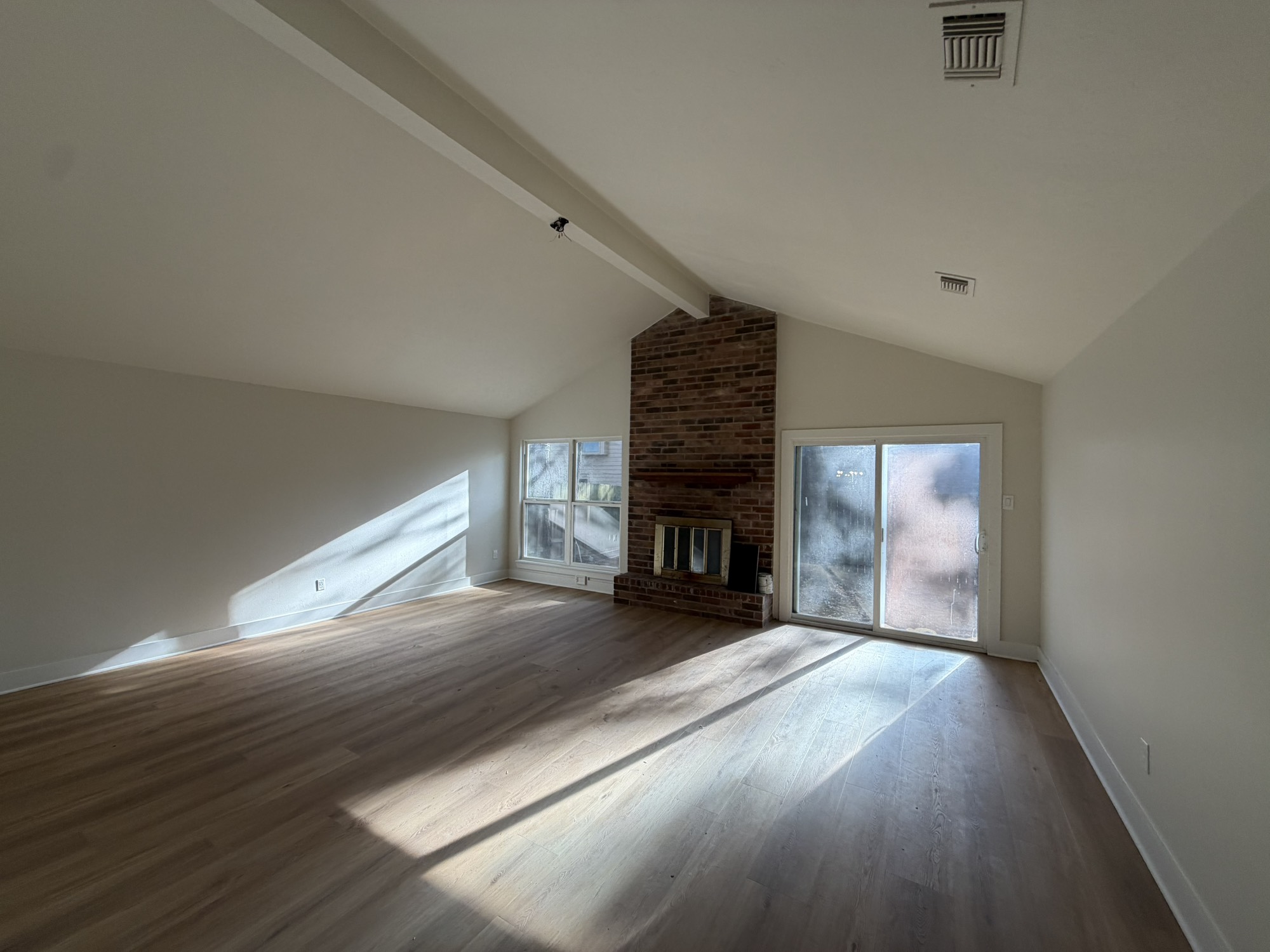 70 Brookflower Road Spring, TX 77380 - Photo 14 of 16 a view of an empty room with wooden floor fireplace and a window