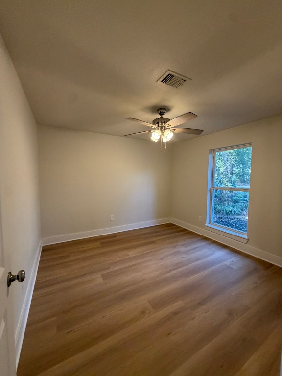 70 Brookflower Road Spring, TX 77380 - Photo 3 of 16 a view of an empty room with wooden floor and a window