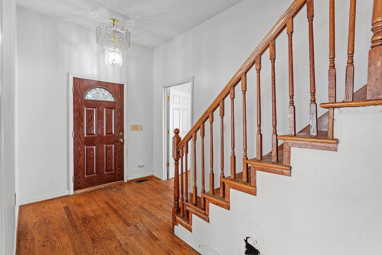 24 Dixie Trail Raleigh, NC 27607 - Photo 11 of 38 a view of an entryway with wooden floor and stairs