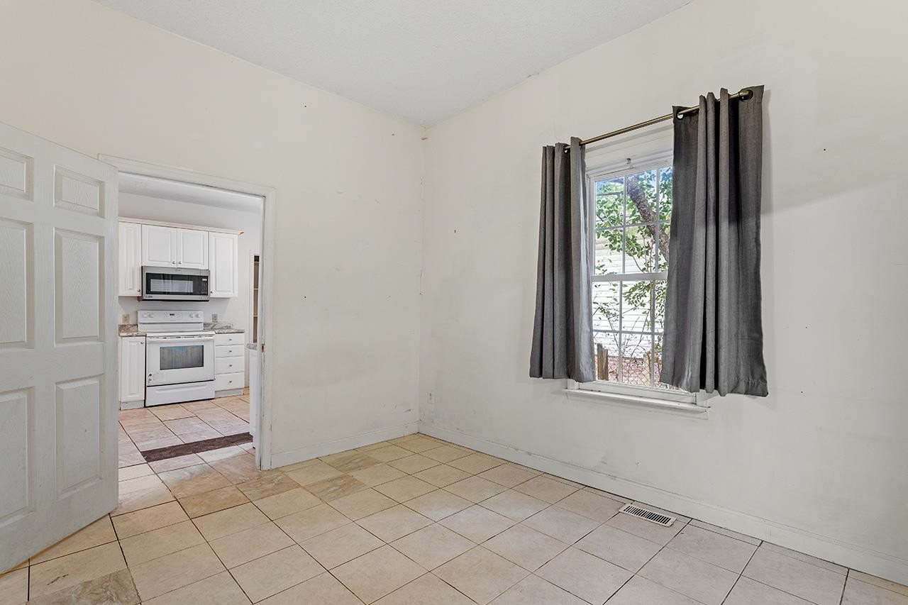 24 Dixie Trail Raleigh, NC 27607 - Photo 17 of 38 an empty room with windows