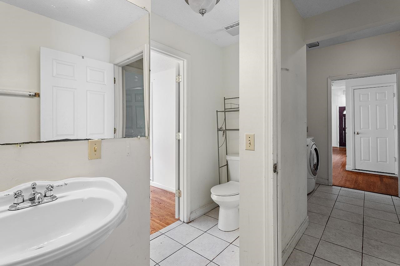 24 Dixie Trail Raleigh, NC 27607 - Photo 24 of 38 a bathroom with a sink a toilet and shower
