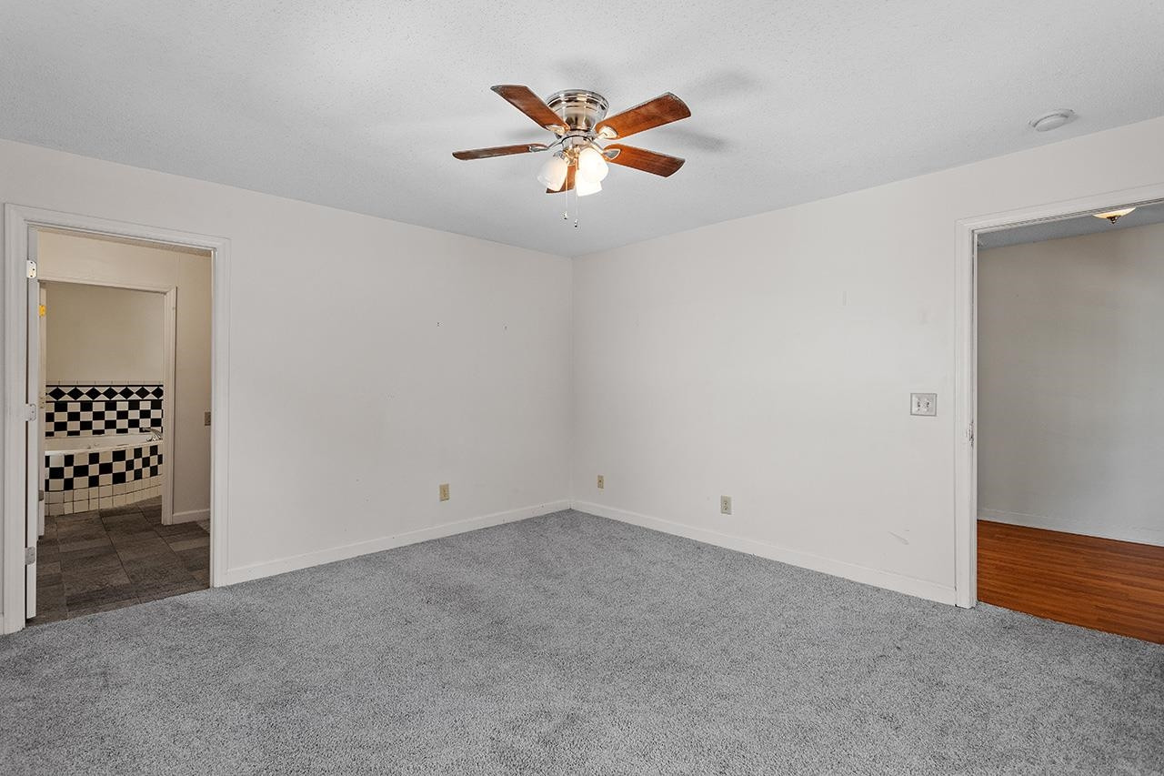 24 Dixie Trail Raleigh, NC 27607 - Photo 31 of 38 an empty room with closet and fan