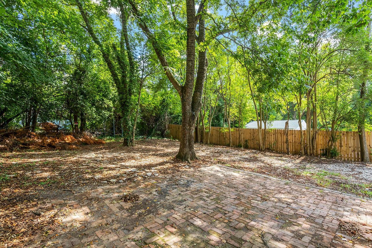24 Dixie Trail Raleigh, NC 27607 - Photo 38 of 38 a backyard of a house with lots of plants and large trees